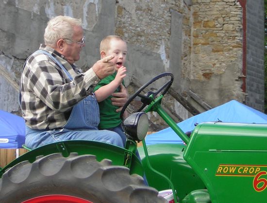 man and boy on tractor