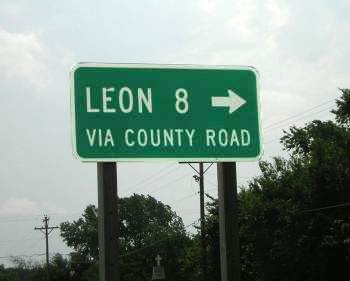 sign to  Leon, Kansas - 8 miles via county road